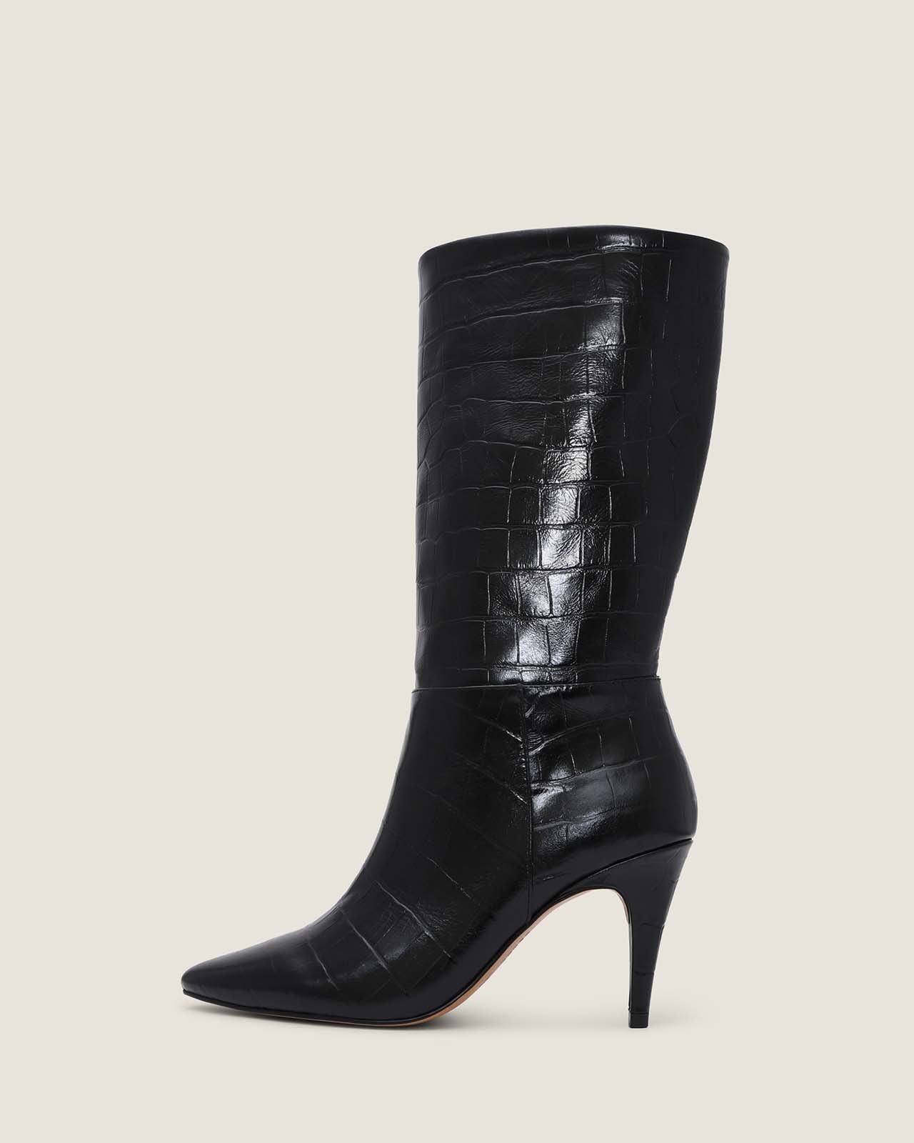 Black crocodile-patterned knee-high boot on a light beige background