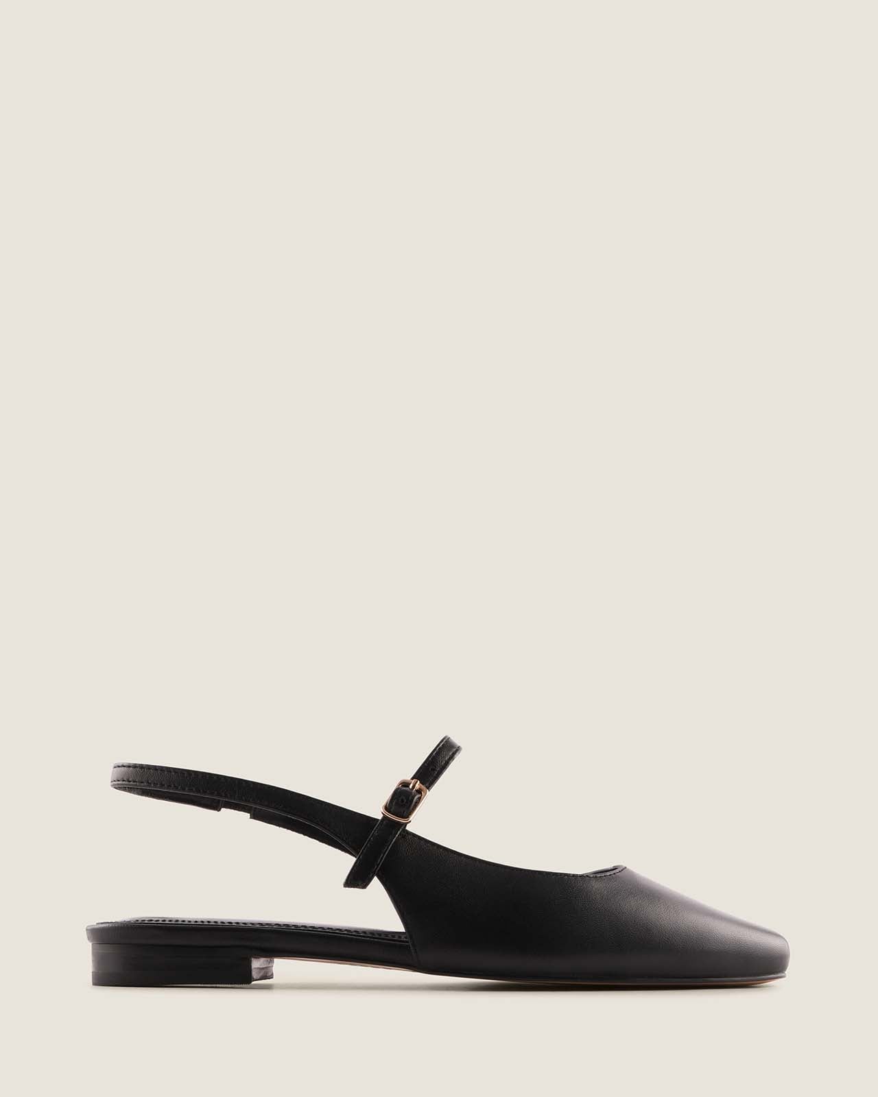 Black leather slingback flat shoe on a light grey background