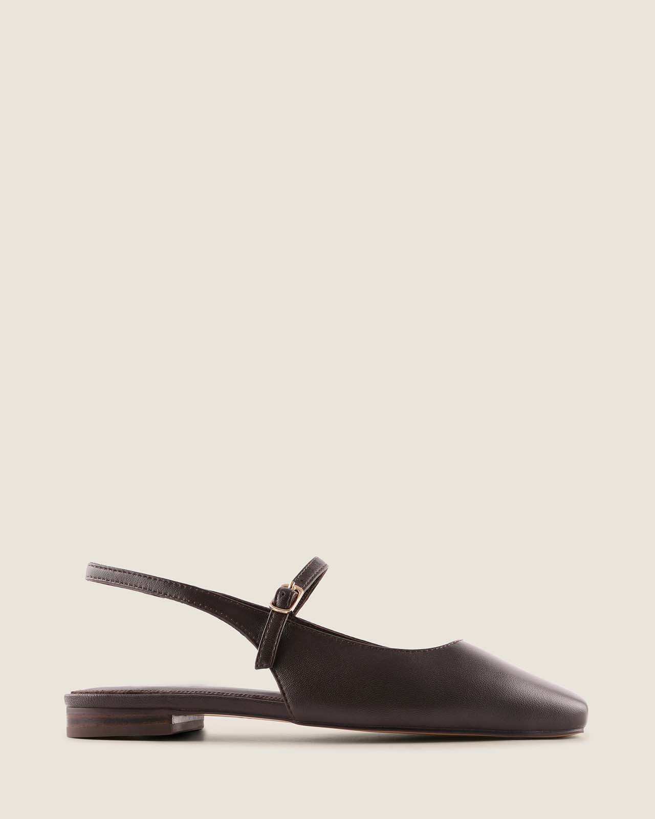 Brown leather dress flat shoe with a slingback strap on a beige background