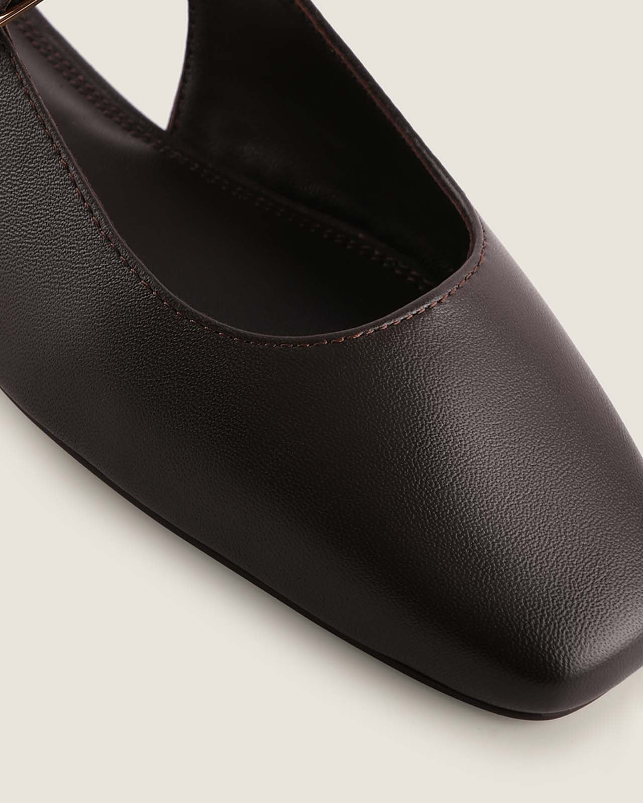 Close-up of a brown leather shoe on a light background