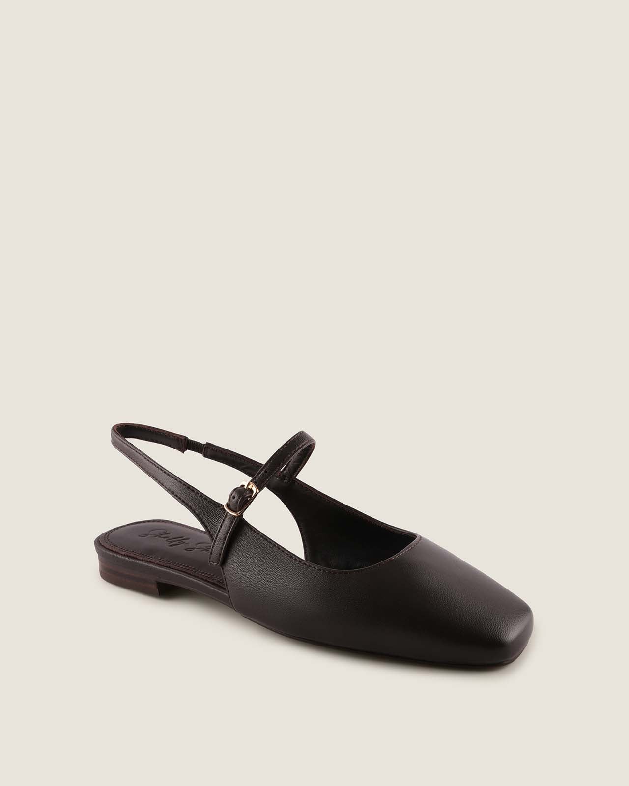 Brown leather dress flat shoe with a slingback strap on a beige background