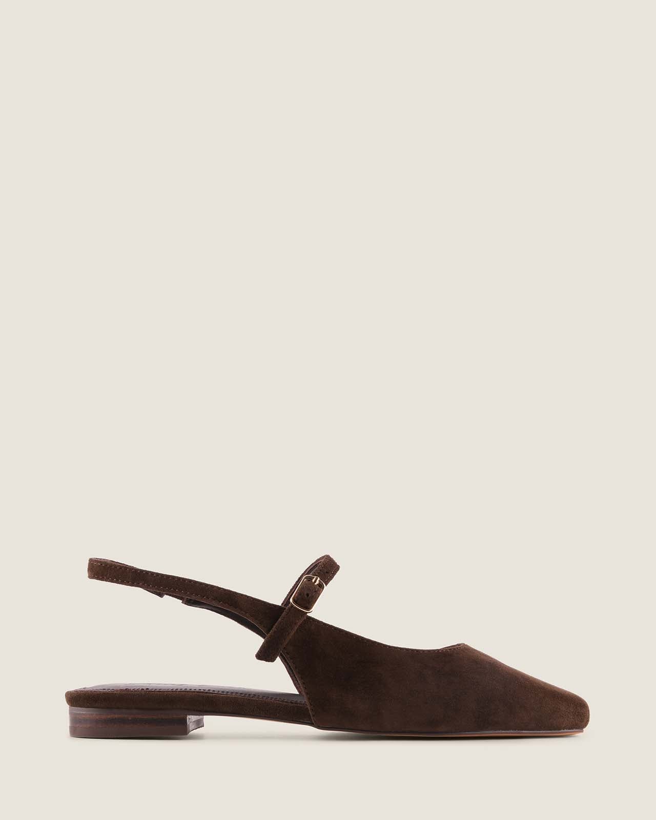 Brown suede flat with a strap on a light beige background