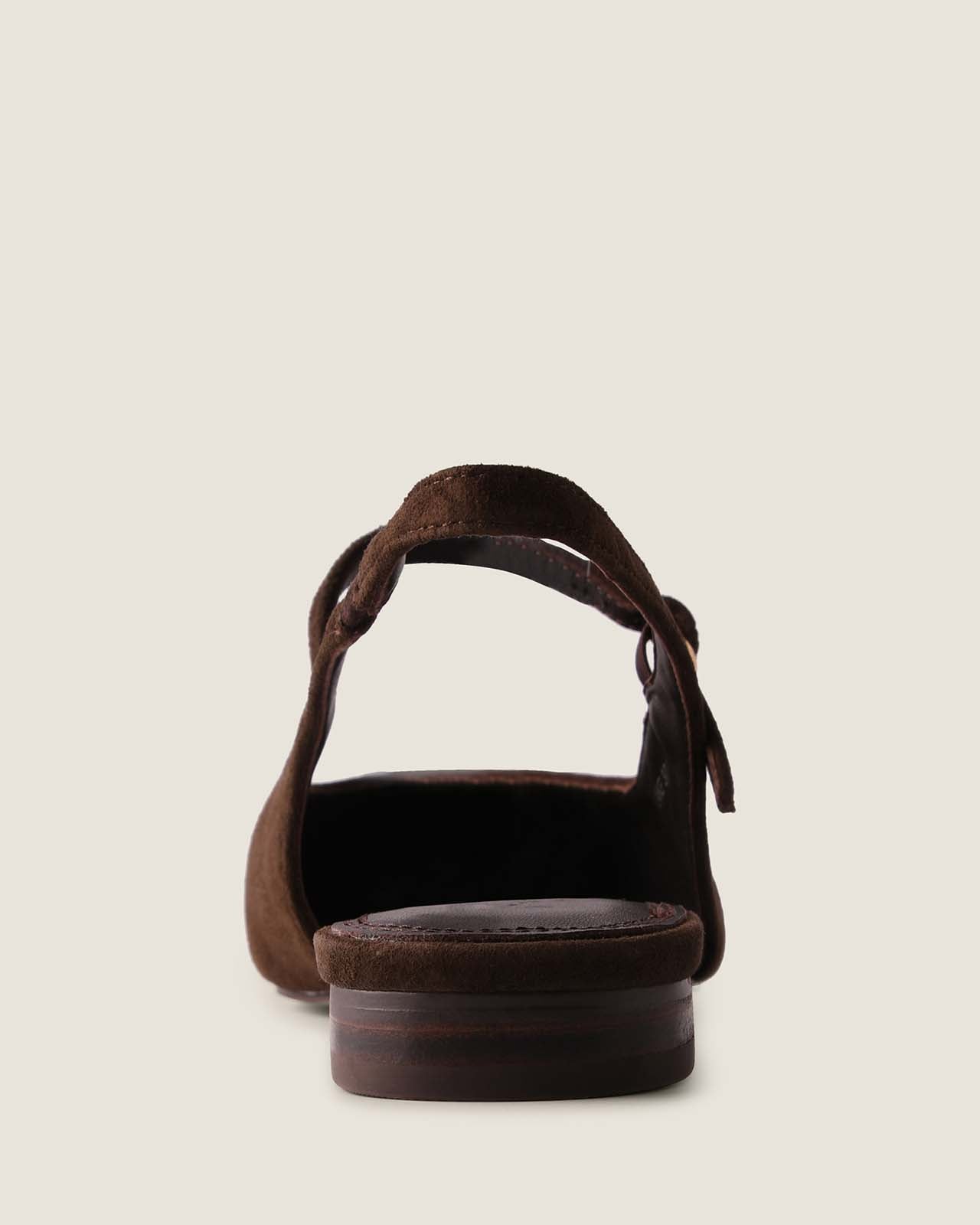 Brown suede dress flat with a thick sole on a light beige background