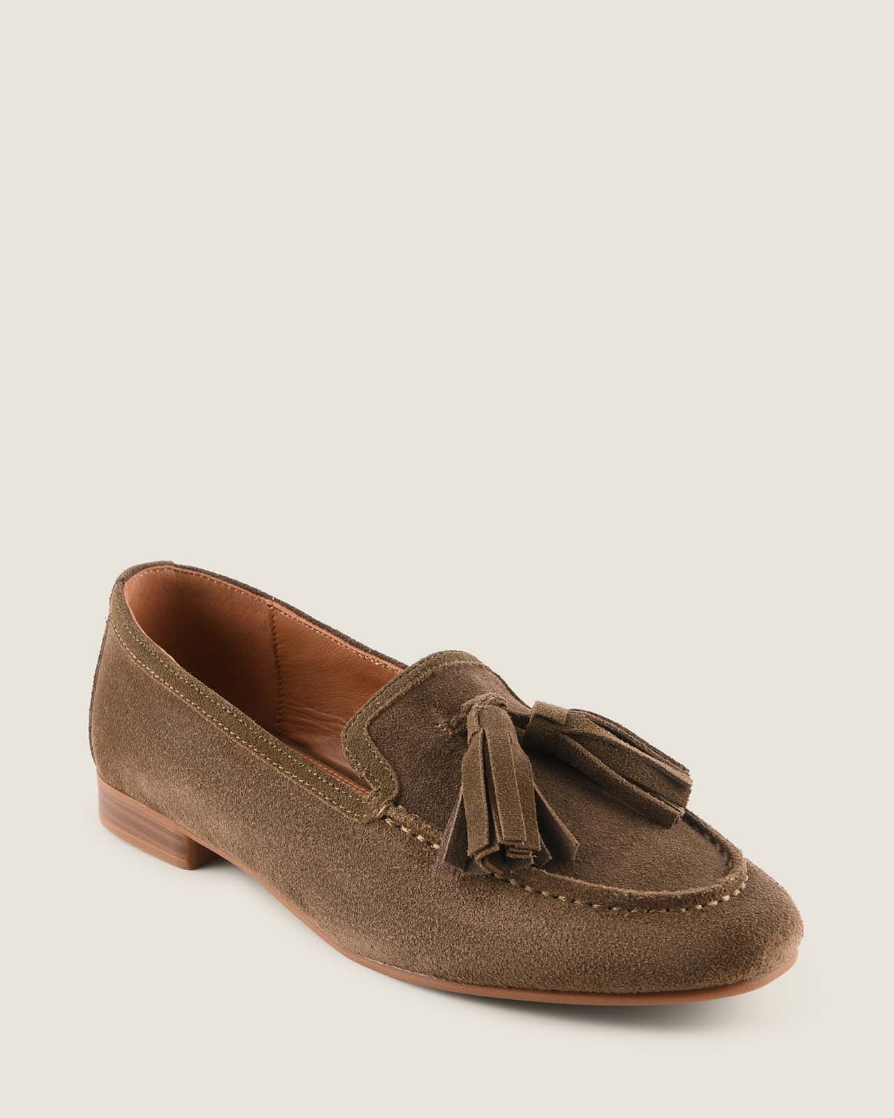 Olive suede loafer with a tassel on a light grey background