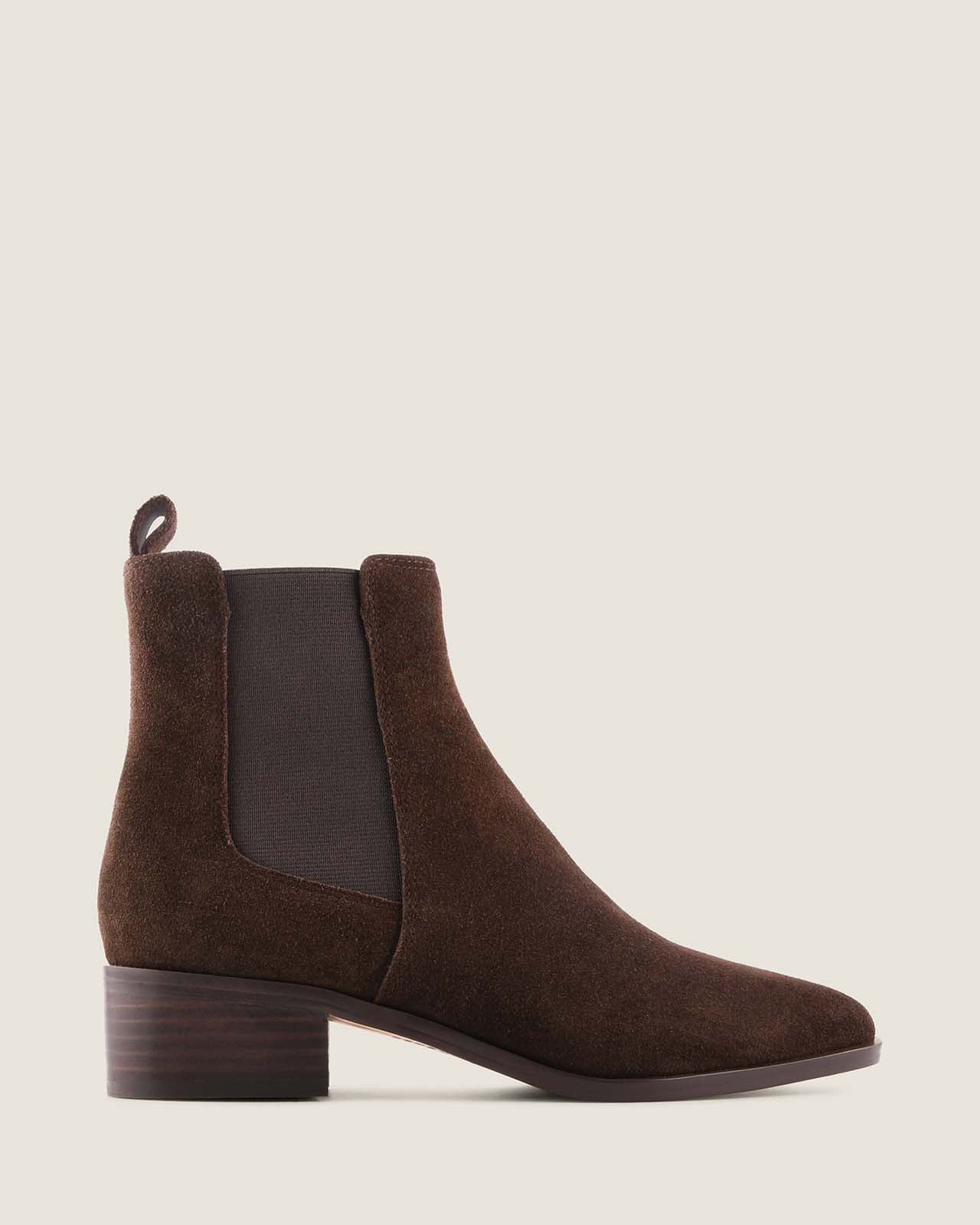 Brown suede boot on a beige background