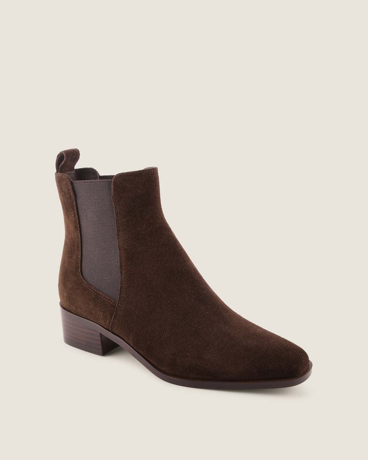 Brown suede boot on a beige background