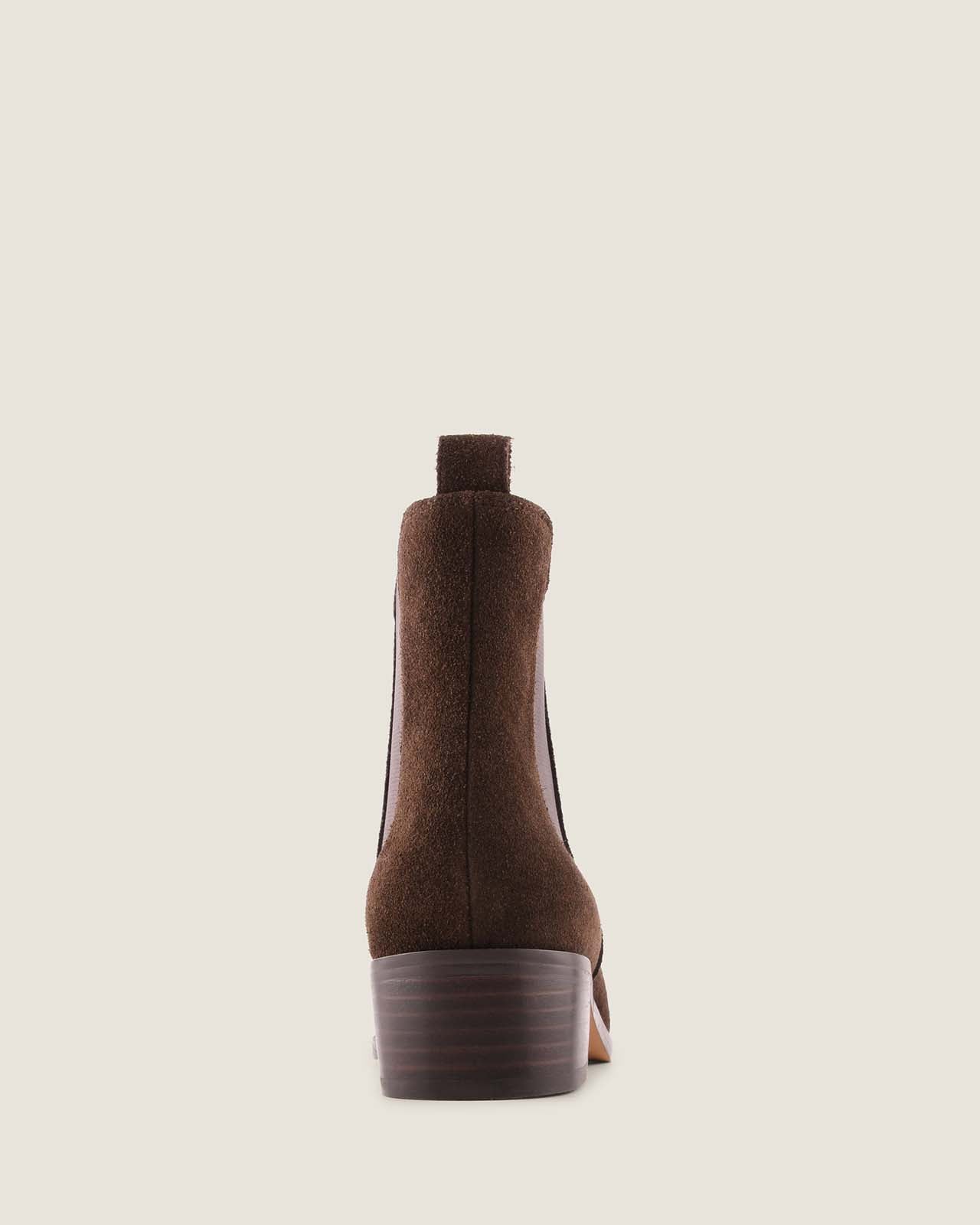 Brown suede ankle boot on a beige background