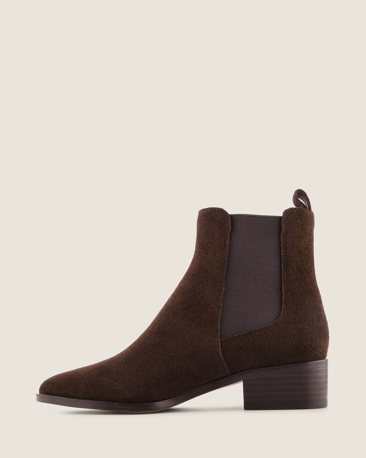 Brown suede ankle boot on a beige background