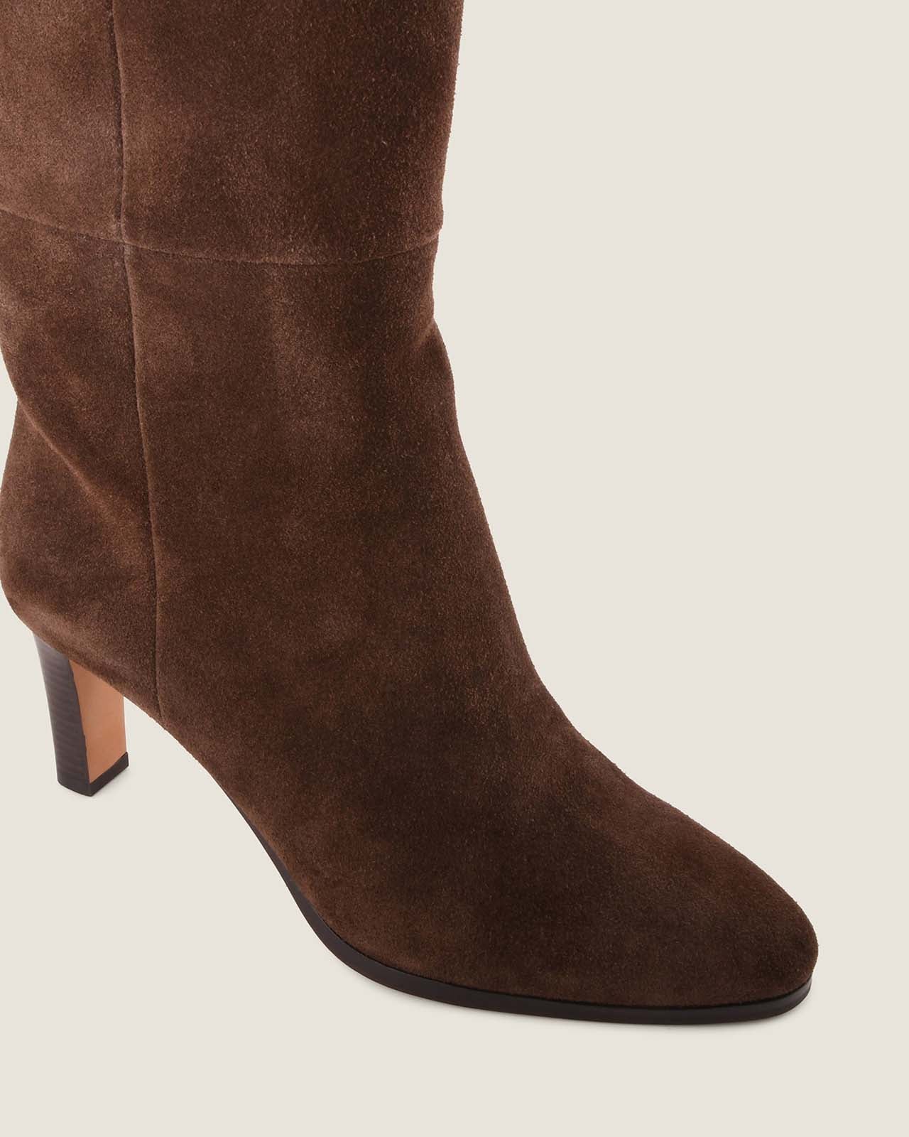 Brown suede knee-high boot on a light grey background
