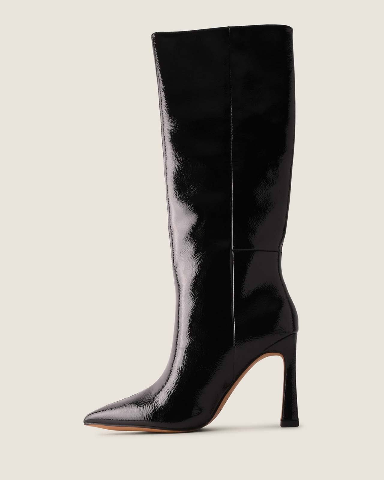 Black knee-high boot on a light gray background