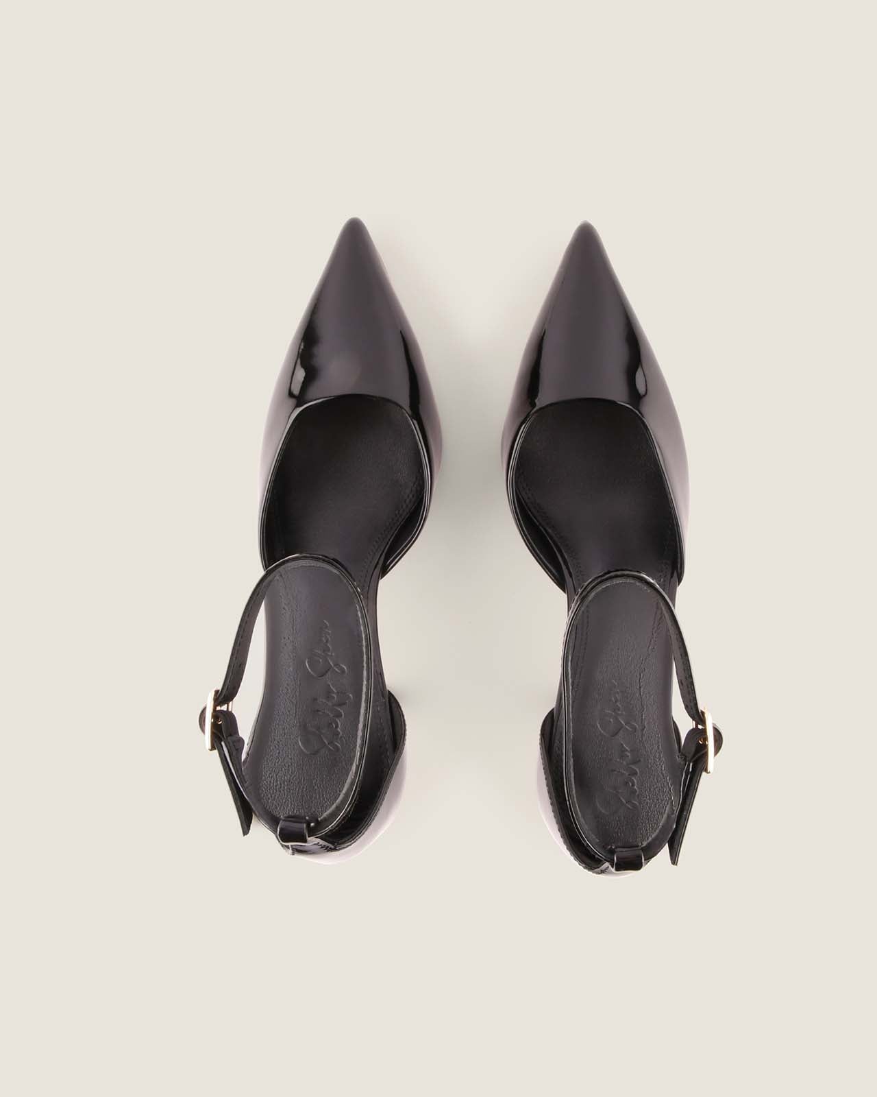 Pair of black high-heeled shoes on a light gray background