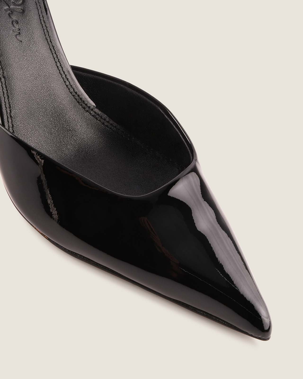 Black pointed-toe high-heeled shoe on a light gray background