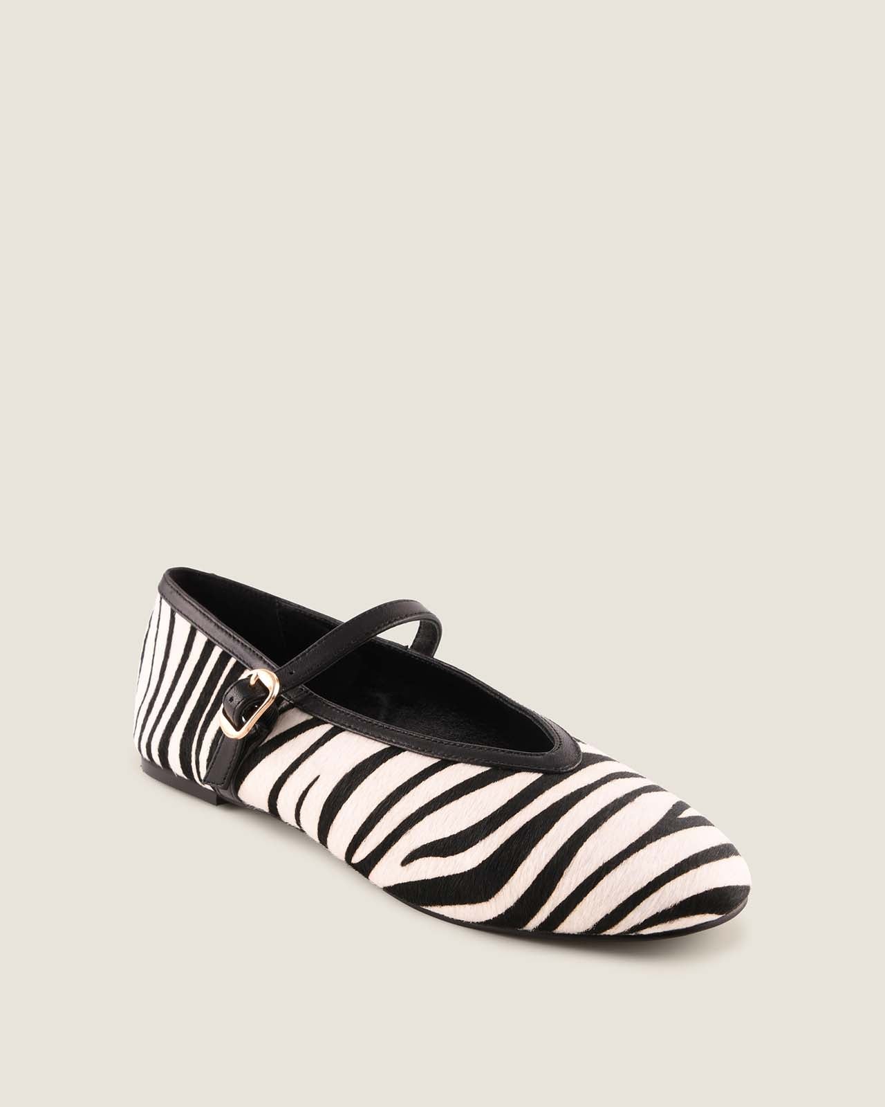 Zebra-striped shoe with a strap on a beige background