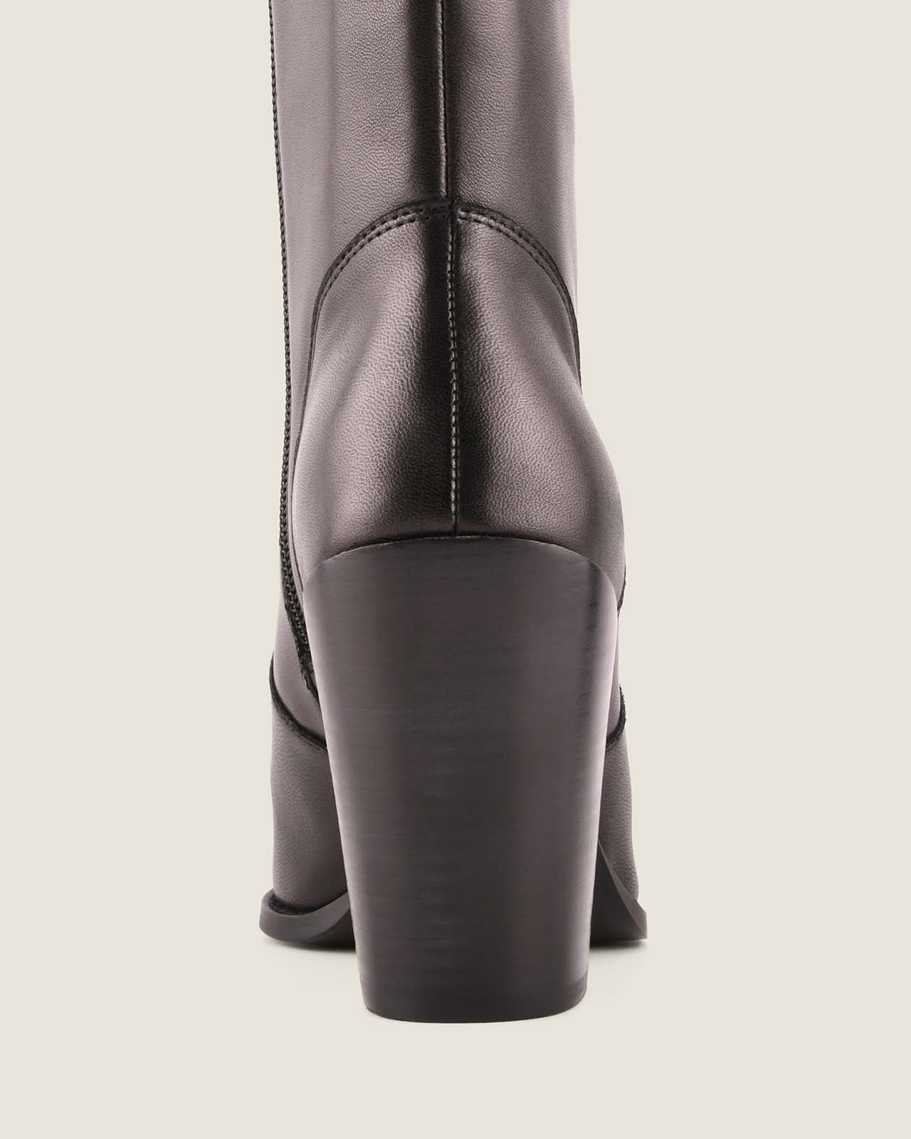 Dark gray knee-high boot on a light beige background