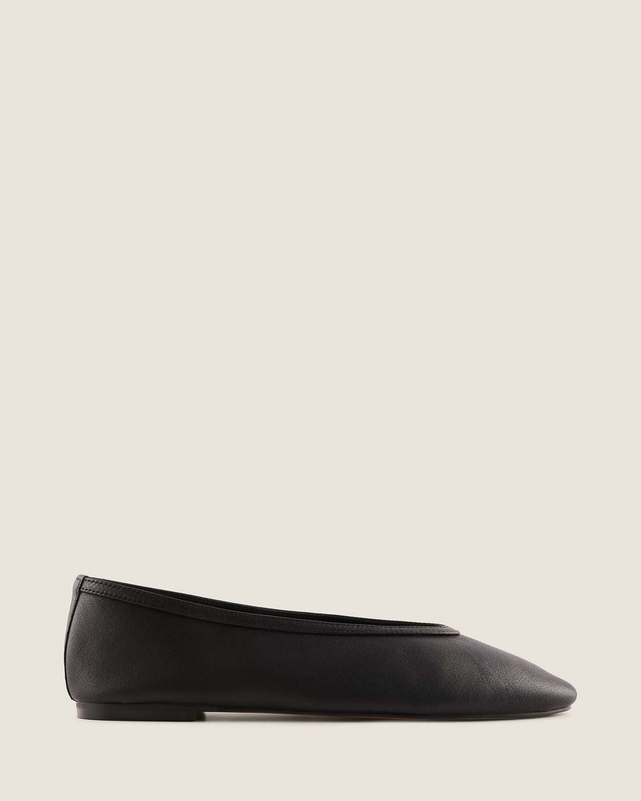 Black flat shoe with a bow on a white background
