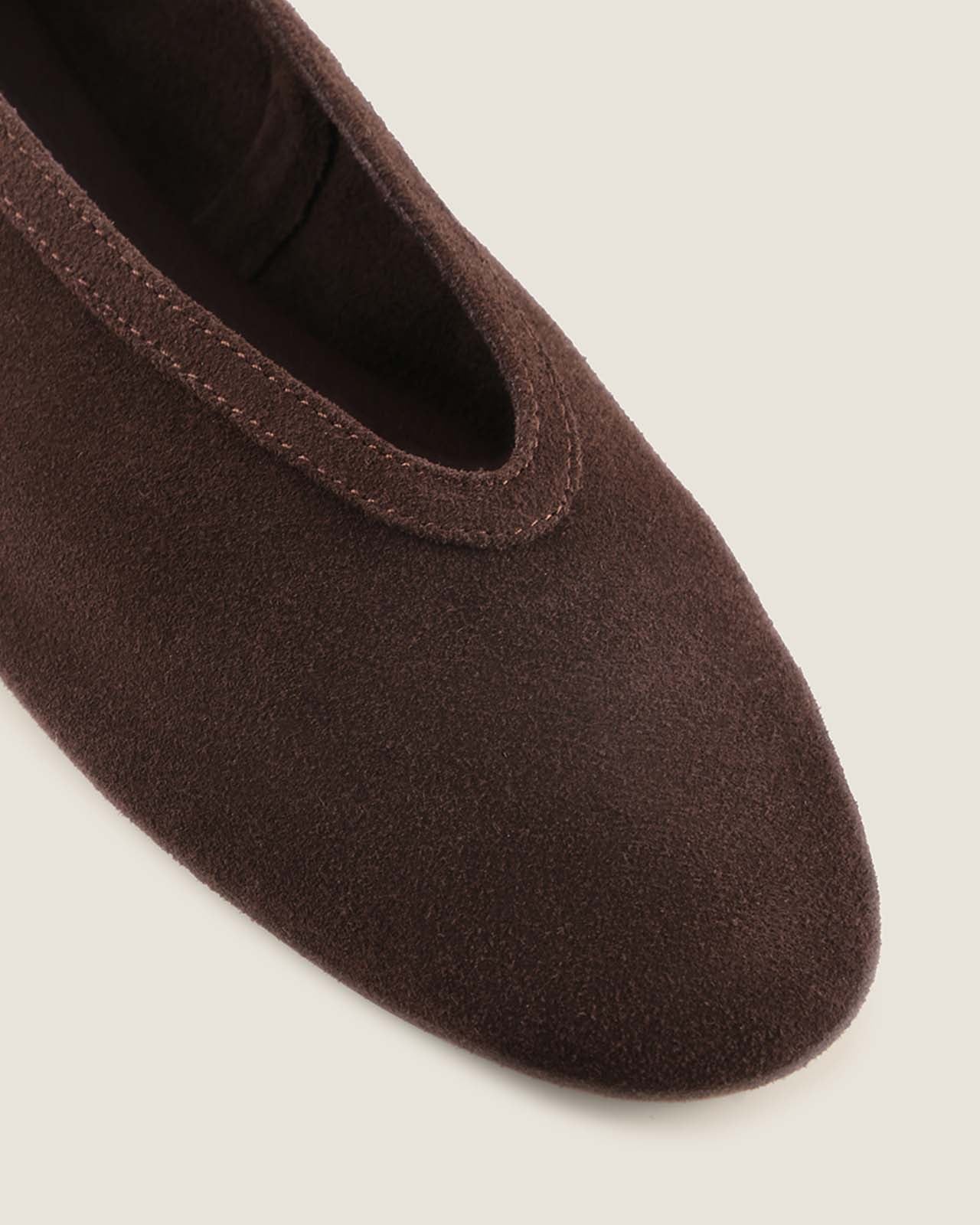 Brown shoe on a light gray background
