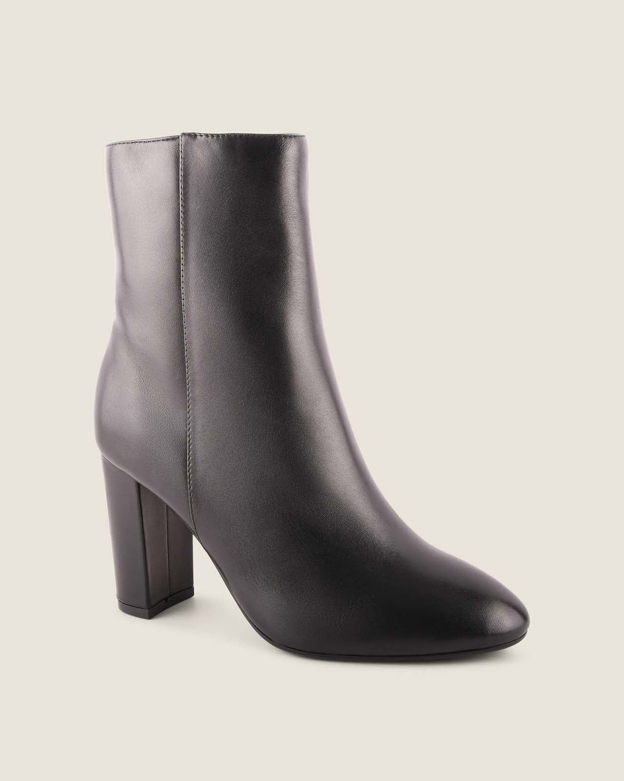 Black ankle boot with a block heel on a light gray background