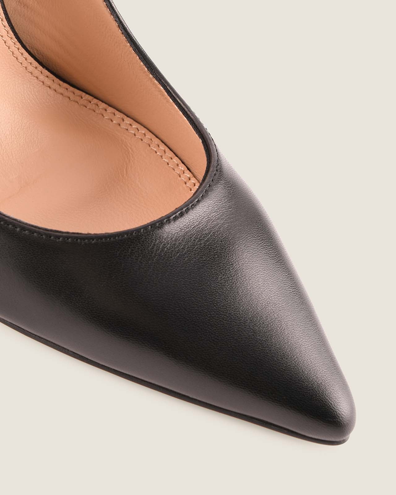 Black pointed-toe shoe on a light gray background