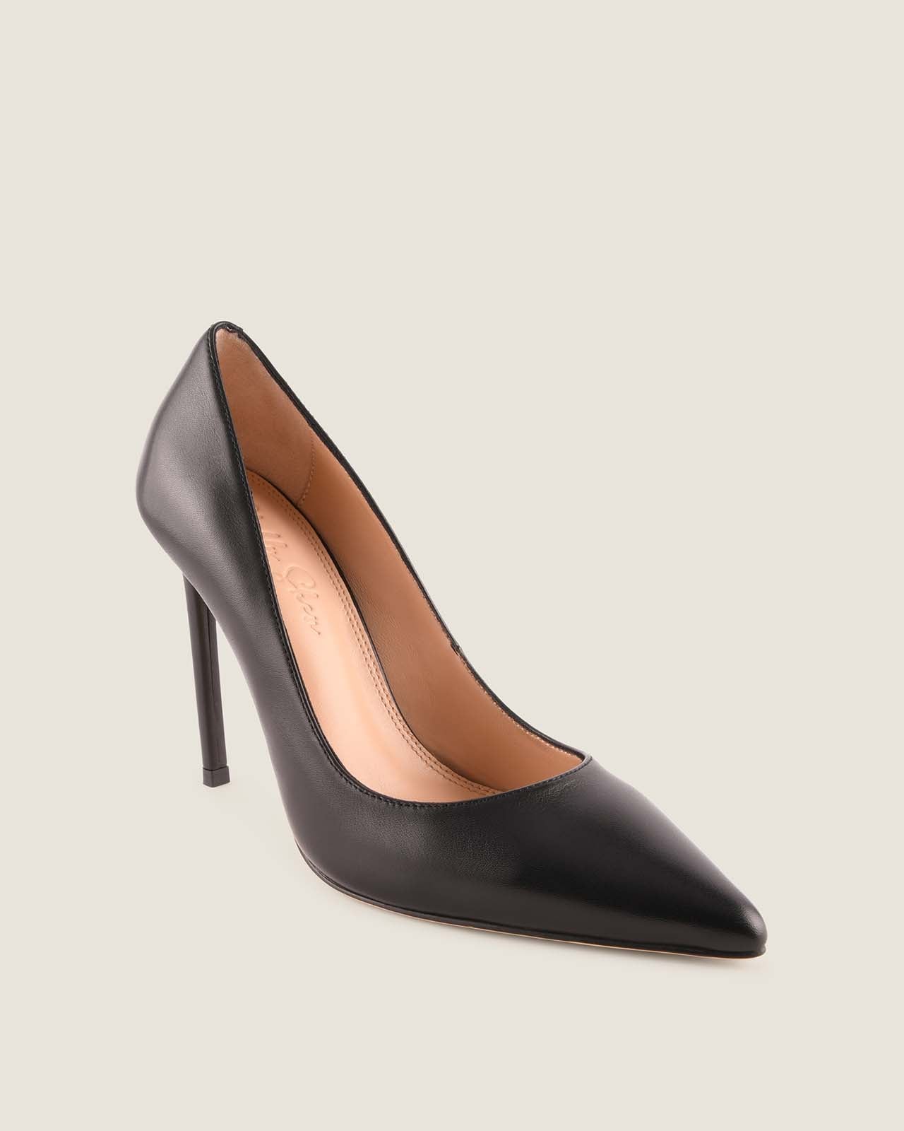 Black high-heeled shoe on a light beige background
