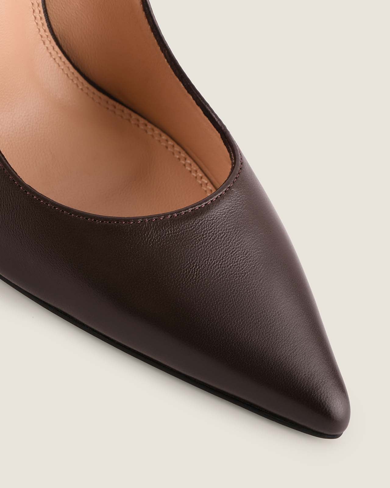 Brown pointed-toe shoe on a light gray background