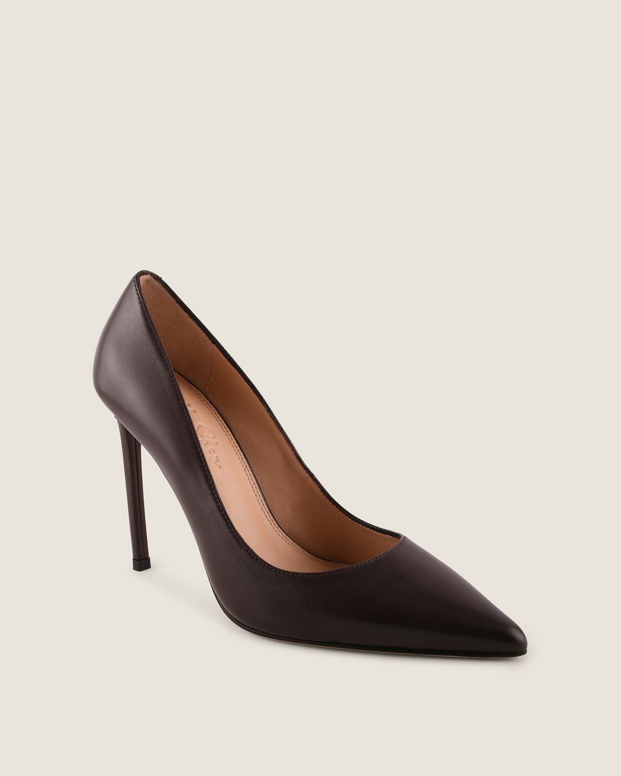 Black high-heeled shoe on a light beige background