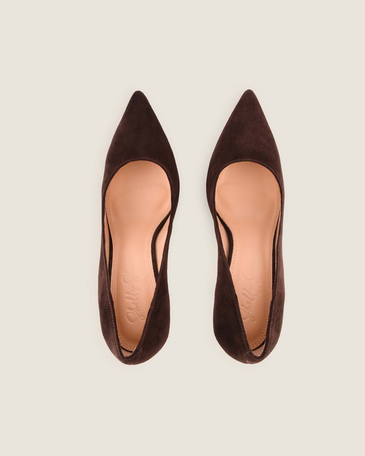 Pair of brown pointed-toe shoes on a light gray background