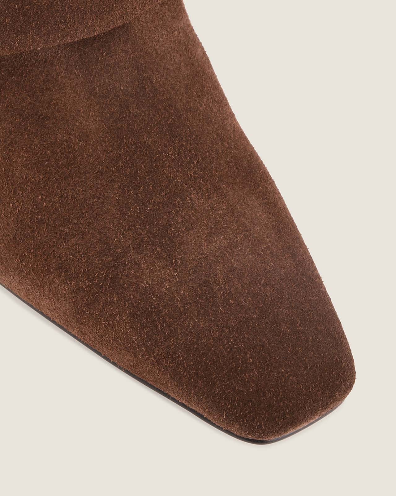 Close-up of a brown sock on a light beige background