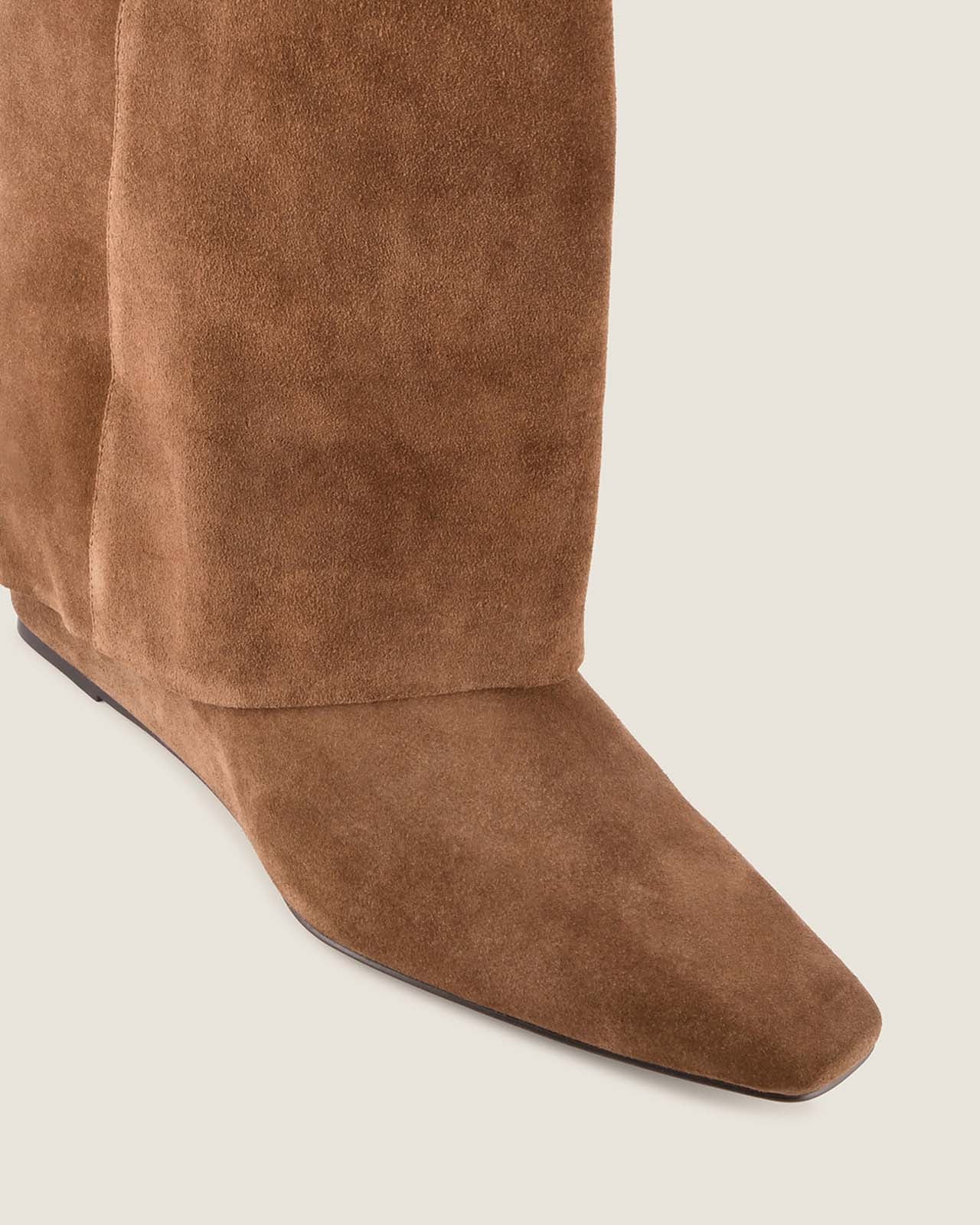 Brown suede knee-high boot on a light gray background
