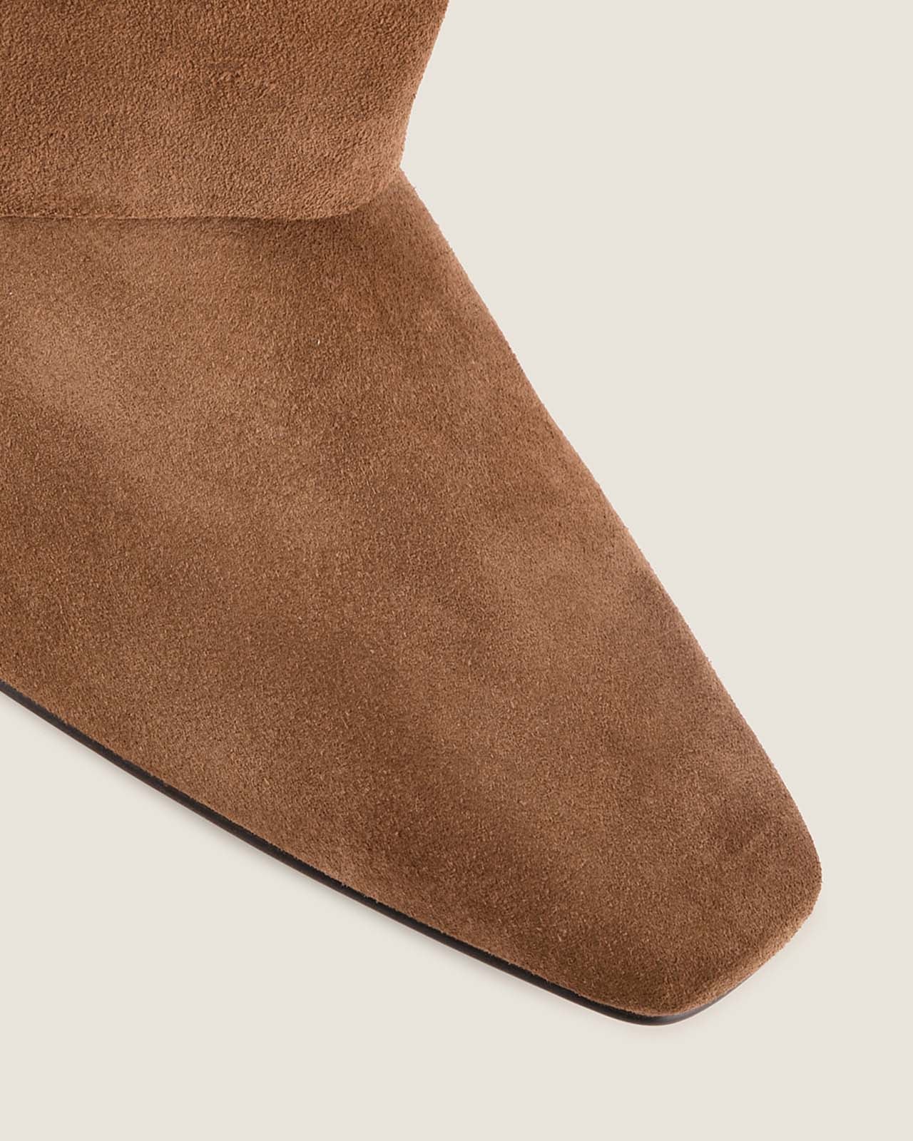 Close-up of a brown suede sock on a light background