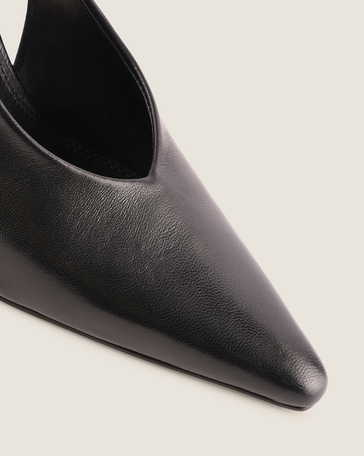 Black pointed-toe shoe on a light gray background