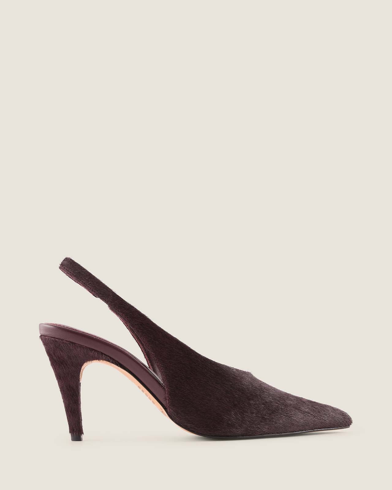 Burgundy ponyhair slingback shoe on a light beige background