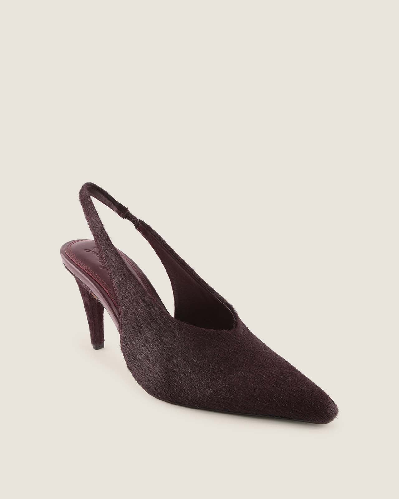 Dark brown slingback shoe on a light beige background